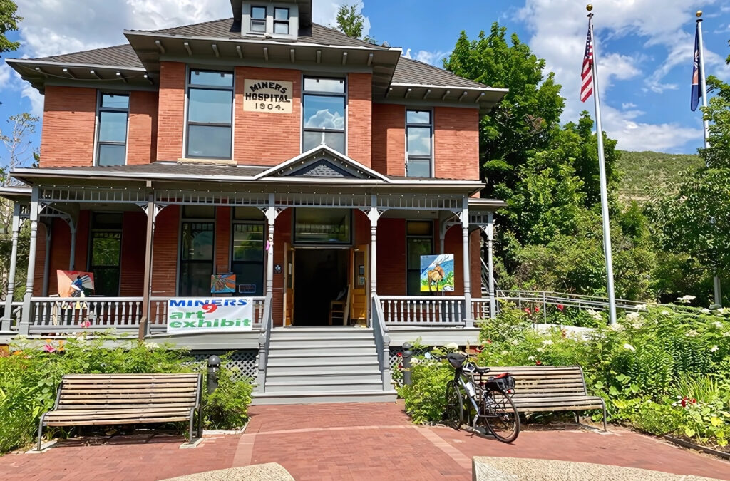 The historic Miners Hospital, built in 1904, serves as the venue for the MINERS9 Art Exhibit in Park City, Utah. The monthly showcase, held the last weekend of each month from April through September, features nine local artists exhibiting fine art and crafts.