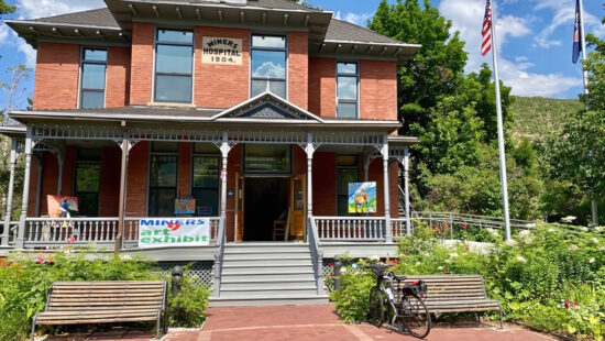 The historic Miners Hospital, built in 1904, serves as the venue for the MINERS9 Art Exhibit in Park City, Utah. The monthly showcase, held the last weekend of each month from April through September, features nine local artists exhibiting fine art and crafts.