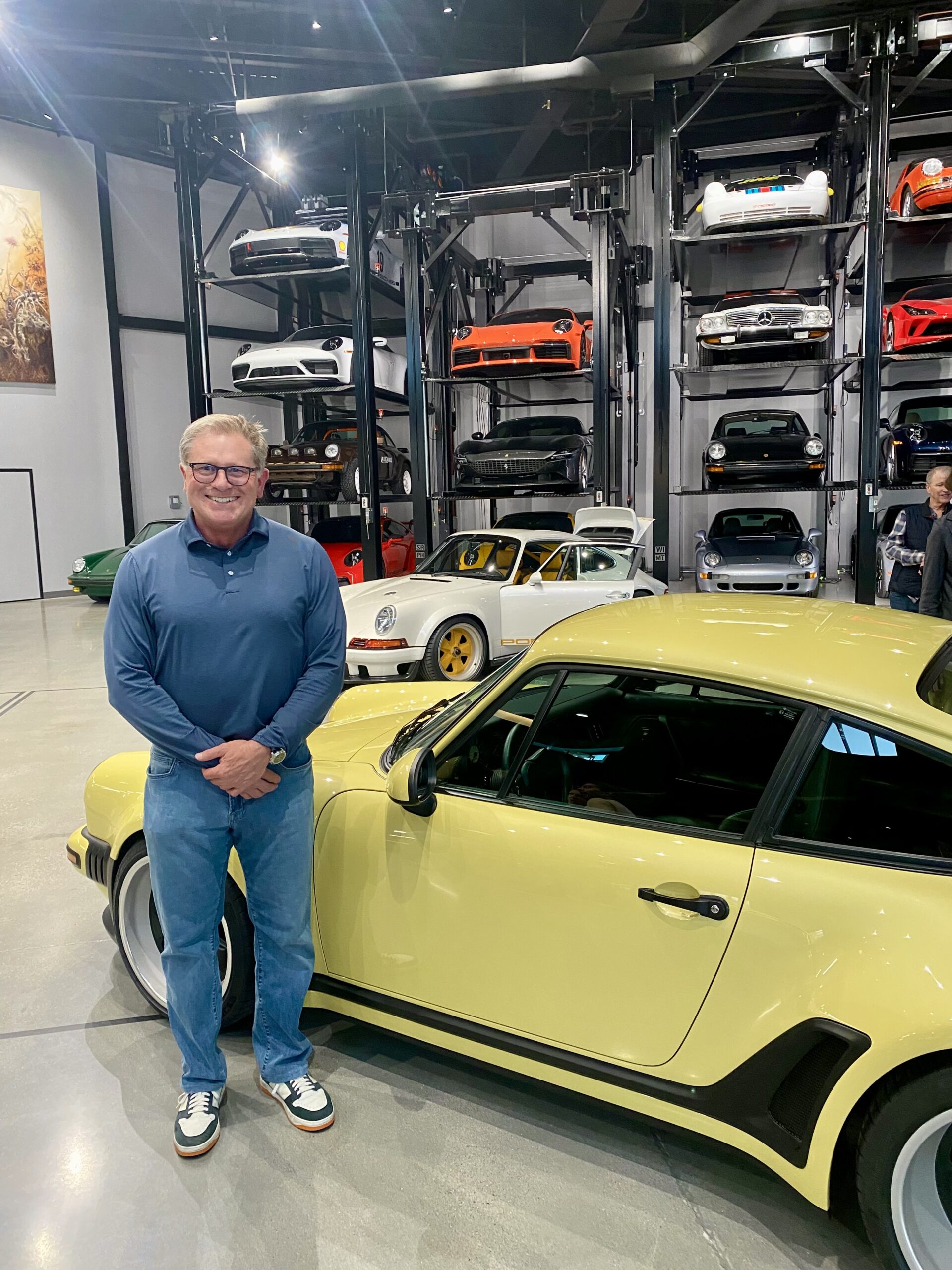 Vern Cooley, M.D. in front of a Stinger Porche at the Warehouse.