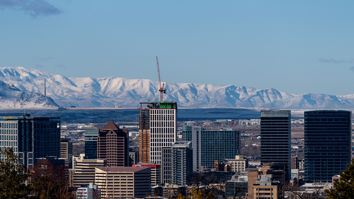 The downtown Salt Lake City skyline is backdropped by fresh snow on the Wasatch Mountains on Monday, January 15, 2024.