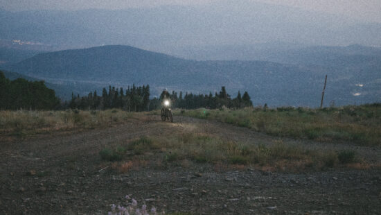 Tomás Parra-Gómez climbs King Road before dawn, headlamp piercing the haze during his 34-hour Everest-height ride in Park City, July 31, 2024.