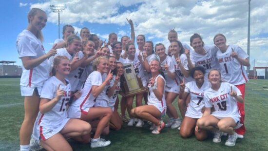 Miners hoist the trophy at the girls lacrosse Utah high school state championship game.