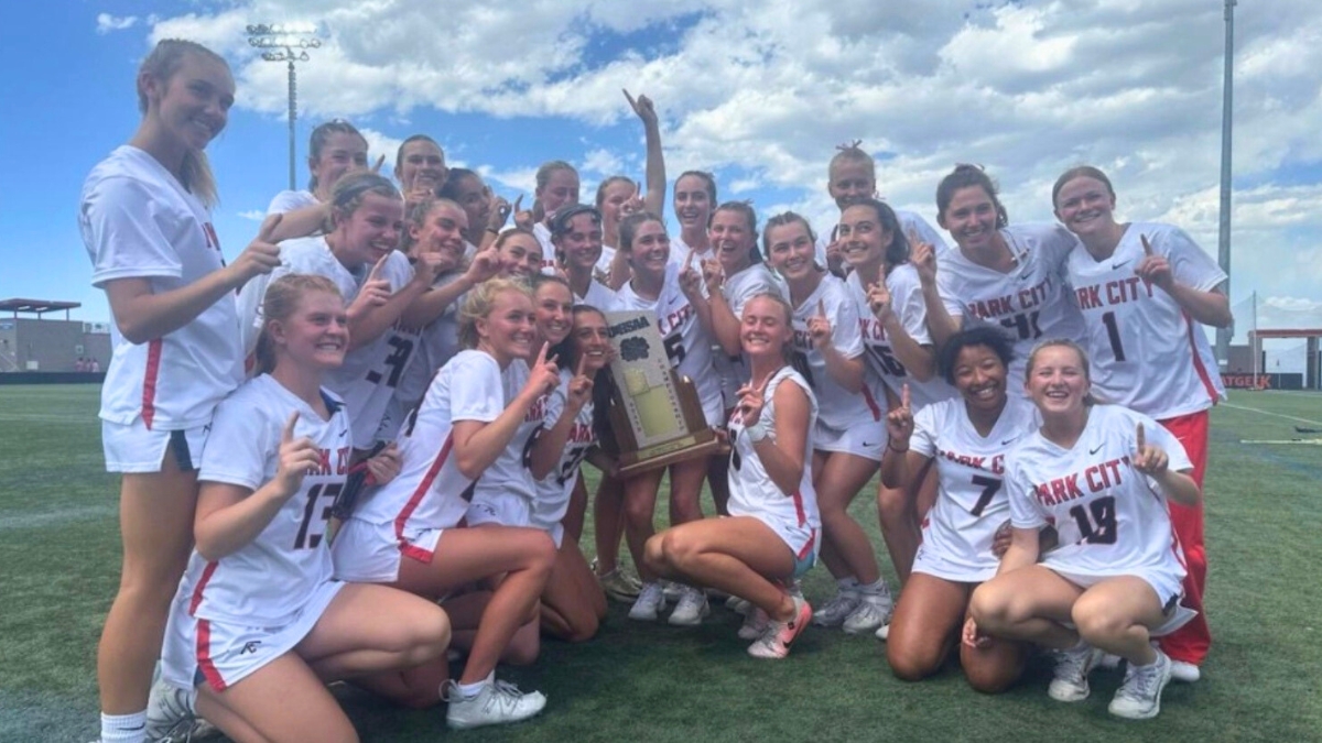 Miners hoist the trophy at the girls lacrosse Utah high school state championship game.