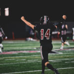 Park City senior Bash Bodily (#14) celebrates during a home game under the lights, part of a football program that has sent more than 30 players to college since 2020.