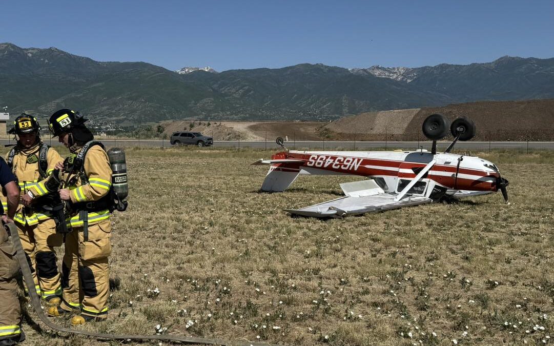 An overturned aircraft rests on the grass at Heber City Airport after a failed landing attempt on June 17, 2025. The pilot, practicing grass landings, escaped with only minor injuries.