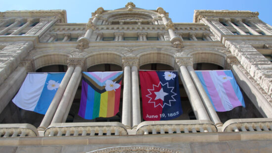 Flags adopted as official banners of Salt Lake City, circumventing the state’s ban on most flags being displayed at government buildings and schools, hang outside the Salt Lake City and County building on Wednesday, May 7, 2025. The official city flags include the Salt Lake City flag, pride flag, Juneteenth flag and transgender flag.