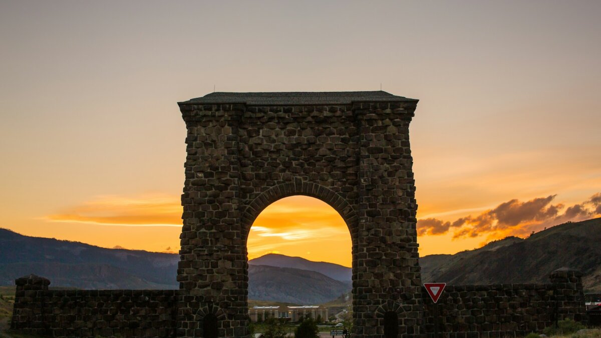 brown concrete arch under gray sky