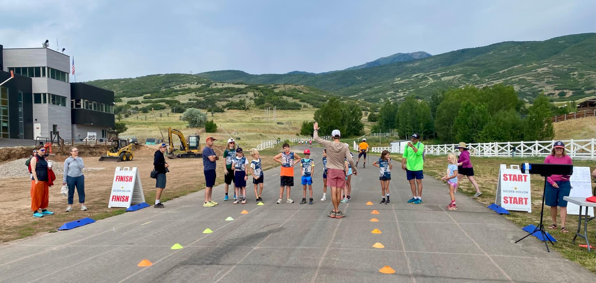 2x nordic combined Olympian from Steaboat Springs Todd Wilson (in bright green shirt) coaching 6 year old athlete to his right in her first race at Springer Tournee. They ended up running together.