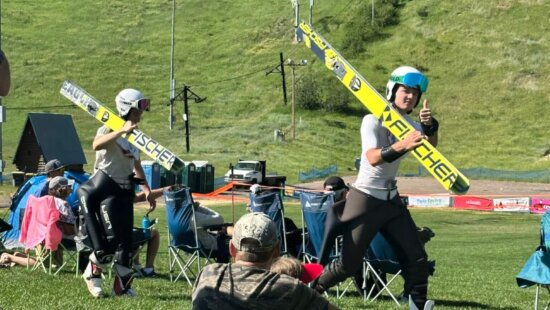 (L-R) Logan Cadman and Augie Roepke with a thumbs-up walking up to their next jump in Steamboat Springs on July 4th.