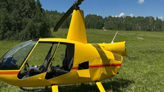 A privately owned helicopter sustained significant damage during the emergency landing, including a detached tail boom and rotor