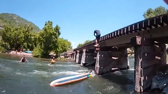 Body cam footage shows paddleboarder trapped against bridge column in Provo River