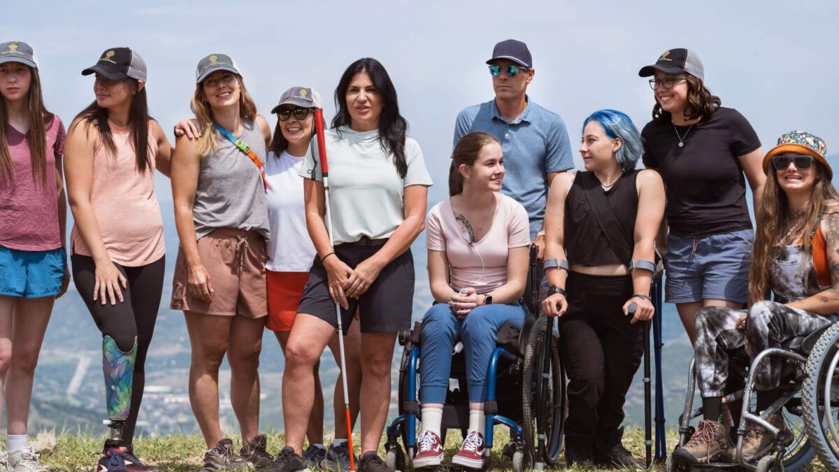 Sisters In Sports Foundation members including President and Founder Danelle Umstead (center holding White Cane).
