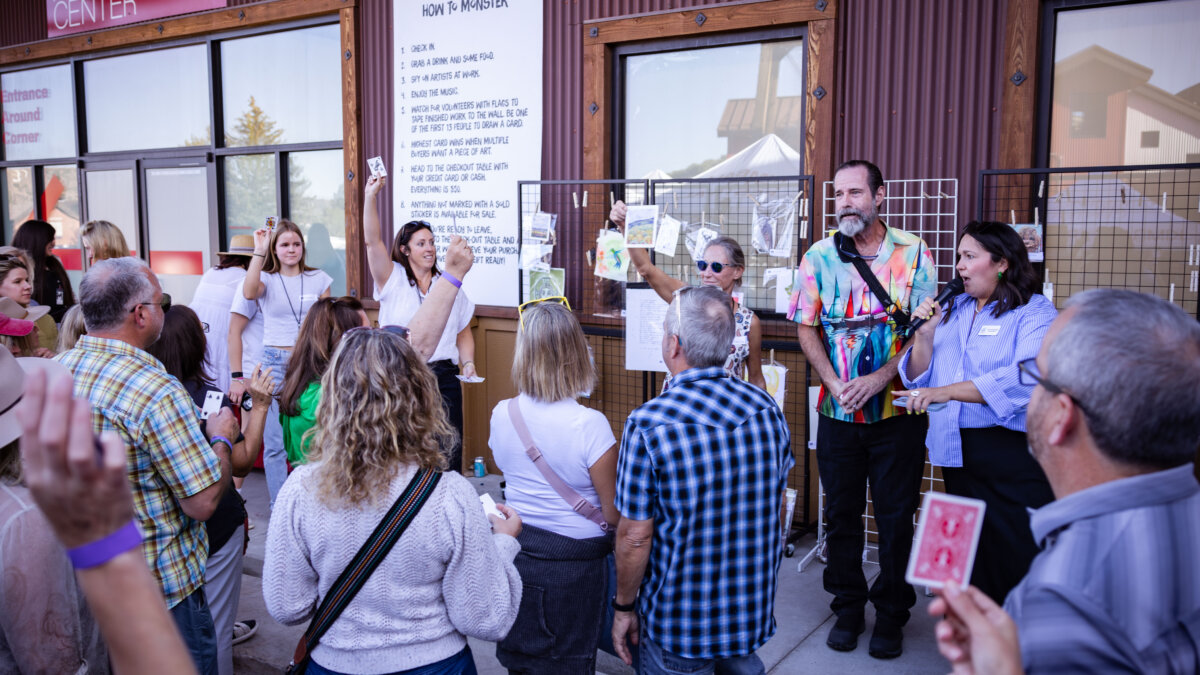 Crowds gather outside Kimball Art Center as artists reveal their finished works during the 2024 Monster Drawing Rally, where original pieces are sold for $50 to support local arts programming.
