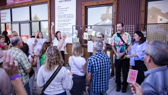 Crowds gather outside Kimball Art Center as artists reveal their finished works during the 2024 Monster Drawing Rally, where original pieces are sold for $50 to support local arts programming.