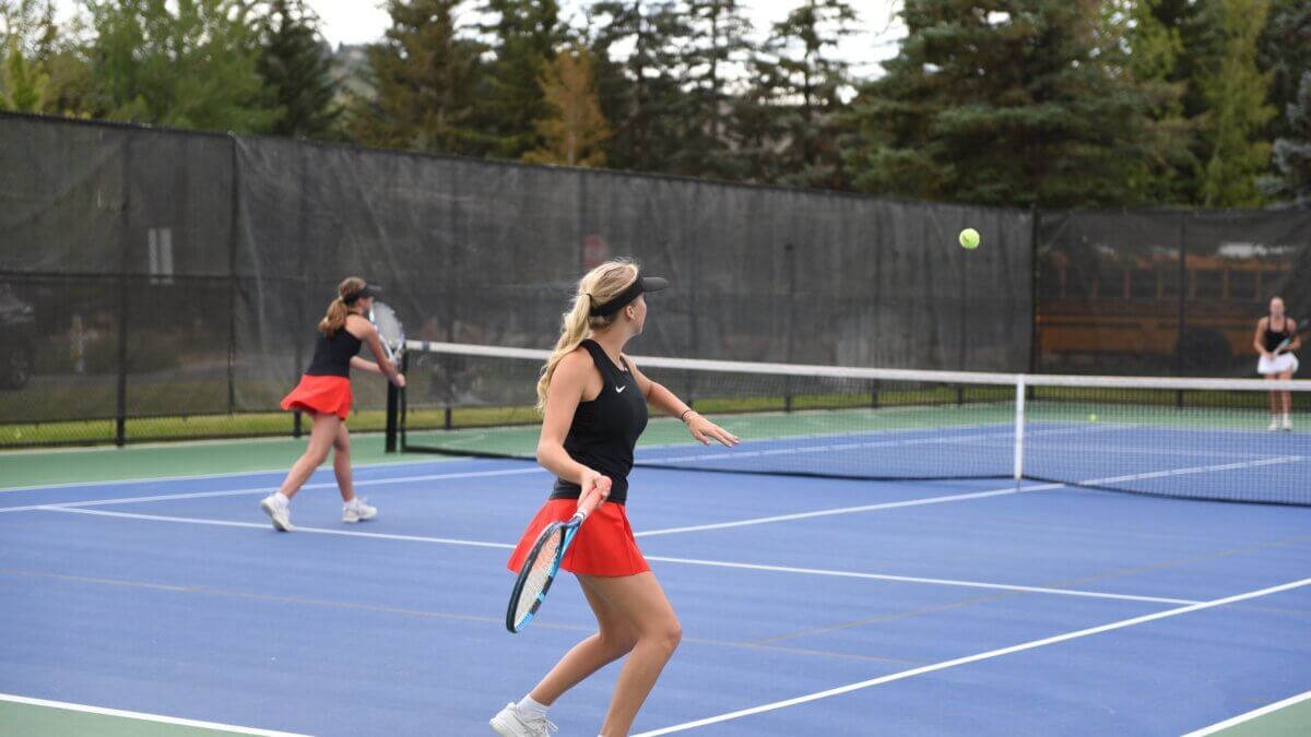 Miners Alix Finkel about to hit the ball and Poppy Rae at the net at the MARC playing Cottonwood.