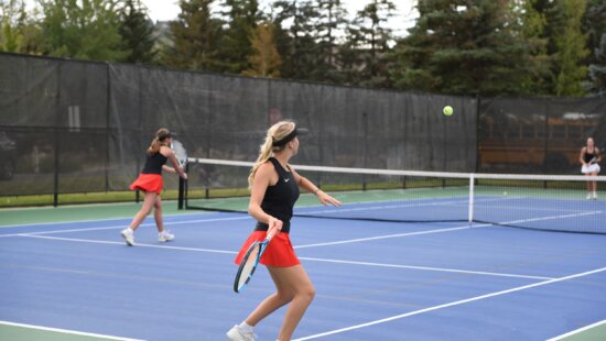Miners Alix Finkel about to hit the ball and Poppy Rae at the net at the MARC playing Cottonwood.