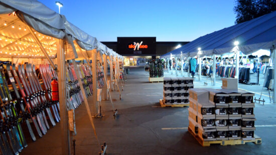 Shoppers browse rows of discounted skis, snowboards, and winter apparel under the tents at Ski ‘N See’s annual Ski-A-Rama sale in Sandy.