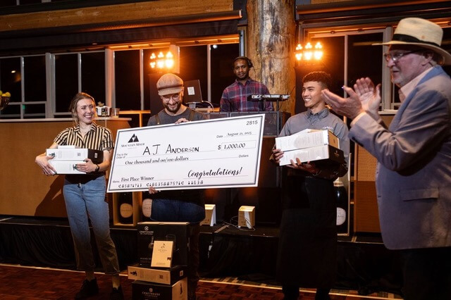 AJ Anderson of Handle holds up his $1,000 prize check after winning the Park City Area Restaurant Association’s Mountain Mixer cocktail contest on Aug. 21, 2025. Anderson’s “Melt” cocktail took first place, with Katelyn Fraser of Butcher’s Chop House & Bar and Charles Vincen Franco of Grub Steak Park City finishing second and third.
