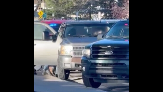 ICE officers in unmarked vehicles with police lights seen physically removing a person from a car near Bonanza Drive in Park City during a federal enforcement action on Sept. 24.