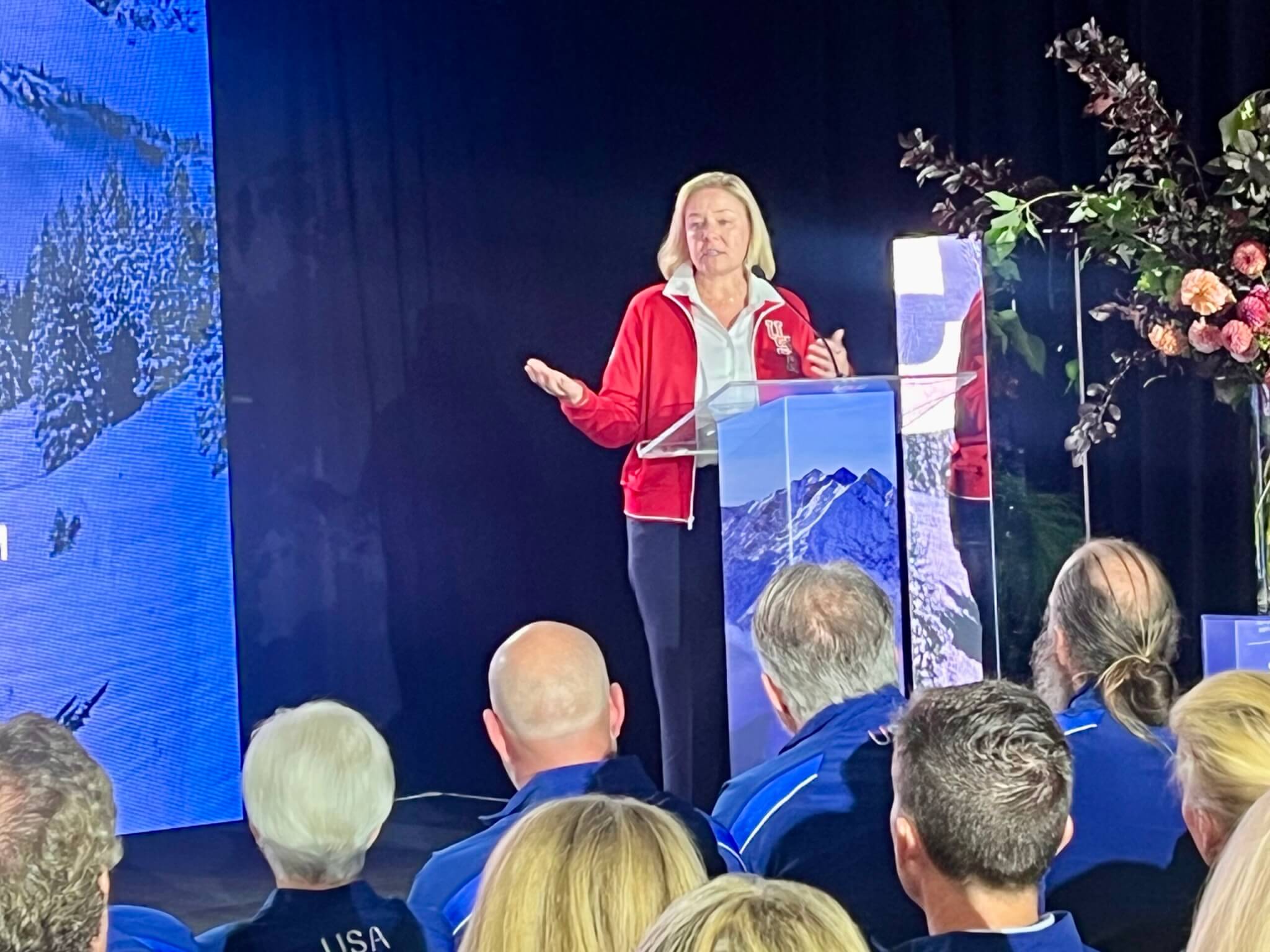 USOPC President Sarah Hirscland in Salt Lake City at the podium on stage in front of the fundraisers delivering the 2034 Olympic preparations, thanking those donors.