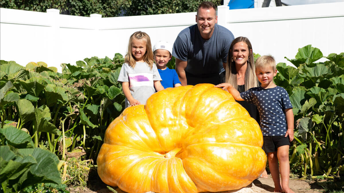 Trenton and Stacey Mason and their children with their 800-pound pumpkin that they grew in 2025.