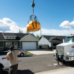 The Masons' 711 pound pumpkin needed to be lifted over their house by a crane.