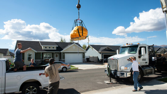The Masons' 711 pound pumpkin needed to be lifted over their house by a crane.