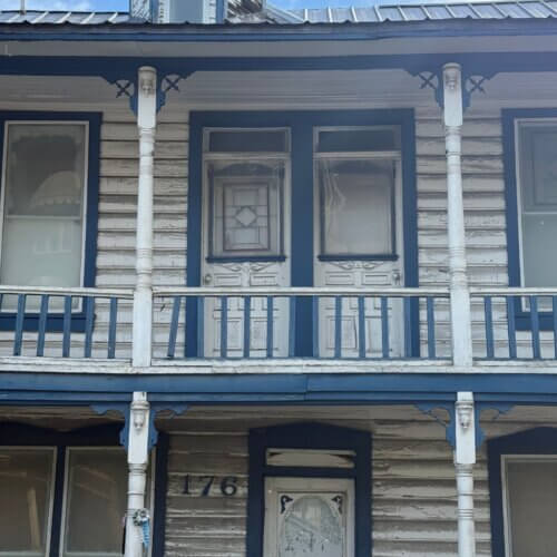"The Centennial" sign is now missing from the second story balcony. 