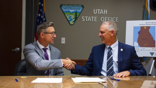 Jerry Davis, BLM Utah Acting State Director, and Scott Strong, Utah DNR State Parks Director, finalize the land conveyance documents at a signing ceremony in the BLM Utah State Office on Aug. 19, 2025.