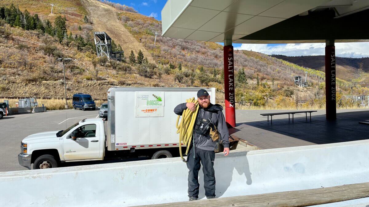 Recreational Bobsled Pilot and Track Tower Operator of Timing and Scoring, Ryan Krusi hauling hoses on ice-making morning.