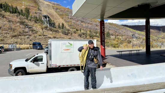 Recreational Bobsled Pilot and Track Tower Operator of Timing and Scoring, Ryan Krusi hauling hoses on ice-making morning.