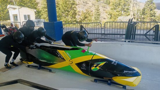 The Jamaican Bobsled Team is sliding bobsleds at the Utah Olympic Park.