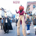 Costume clad Parkites stroll Main Street for a Halloween celebration in Park City.