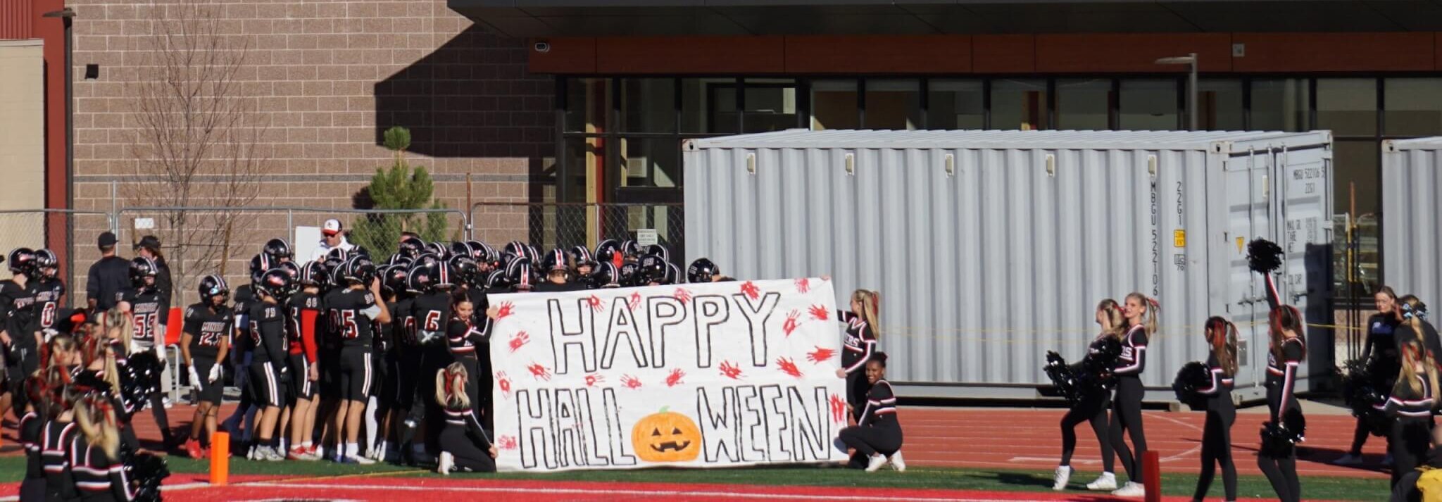 The athletes busted through this banner and ran out onto the field to a rowdy crowd.