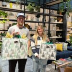 Jake Mulvey (left) and Kristi Wilson (right) pose with their prizes from winning the TownLift Local Holiday Shopping Spree.