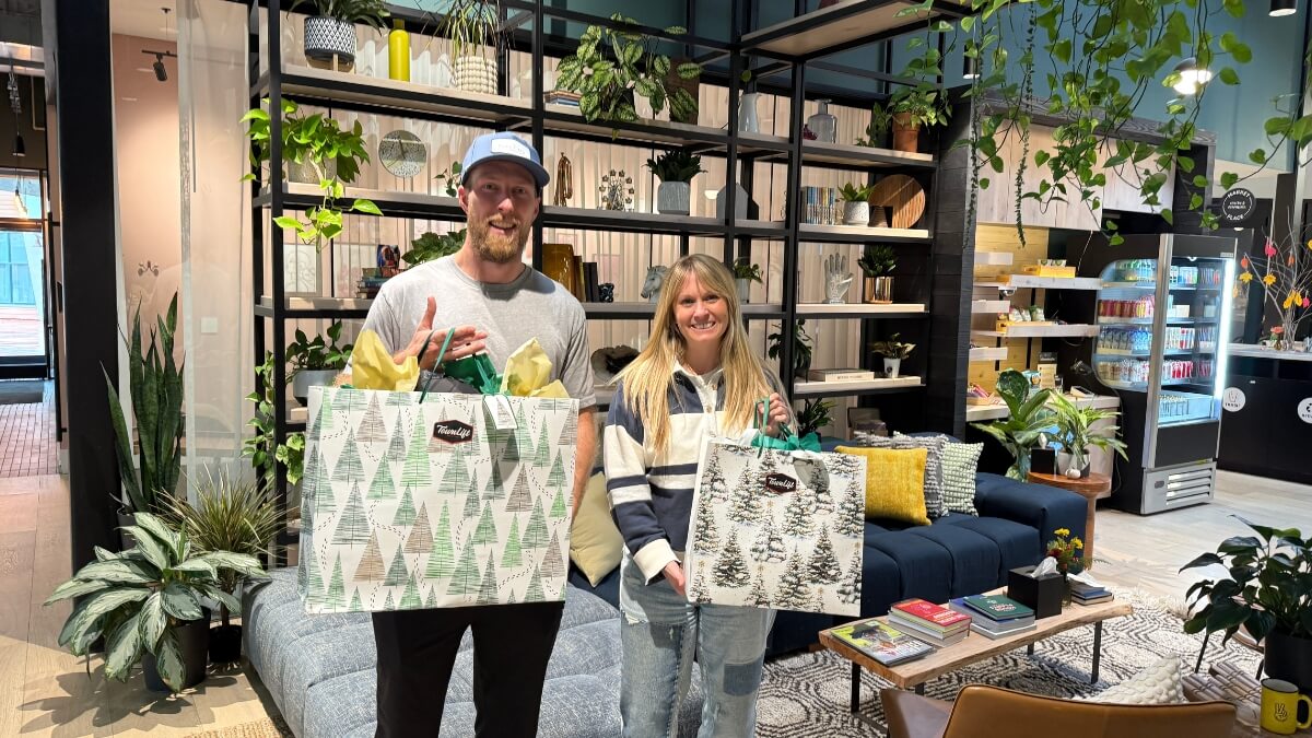 Jake Mulvey (left) and Kristi Wilson (right) pose with their prizes from winning the TownLift Local Holiday Shopping Spree.