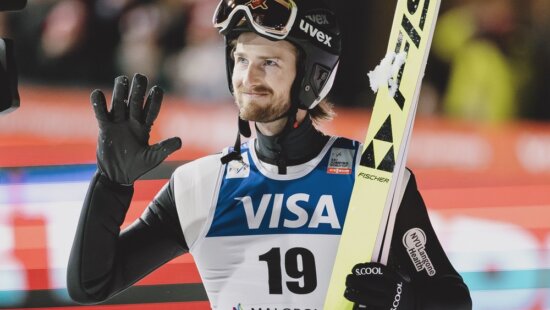 U.S. ski jumper Kevin Bickner waves to fans after a World Cup event. The Park City–based athlete recently returned to competition following a brief retirement and is training in Norway as he eyes a spot at the 2026 Winter Olympics in Milano-Cortina.
