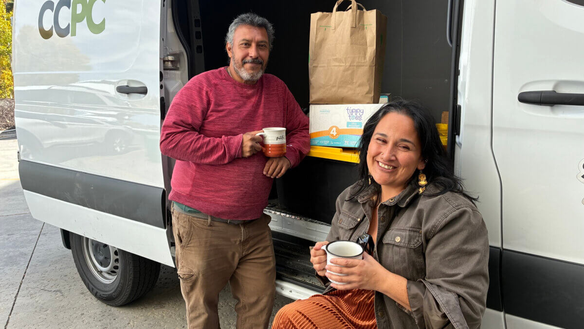 Jaime Mira, left, deputy director of food and security at the Christian Center of Park City, and Valeria Cruz, assistant manager of the nonprofit’s Heber food pantry, pause beside the organization’s delivery van in Park City, Utah.