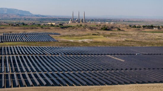 A solar installation in Emery County, with PacifiCorp’s Hunter coal-fired power plant in the background, is pictured on Wednesday, July 31, 2024.