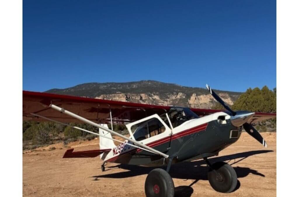 A backcountry aircraft sits on a dirt landing strip near Navajo Mountain on the Navajo Nation during the Back Country Santa holiday airlift, where volunteer pilots deliver boxes of gifts and essentials to remote communities.