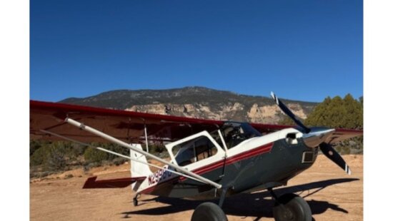A backcountry aircraft sits on a dirt landing strip near Navajo Mountain on the Navajo Nation during the Back Country Santa holiday airlift, where volunteer pilots deliver boxes of gifts and essentials to remote communities.