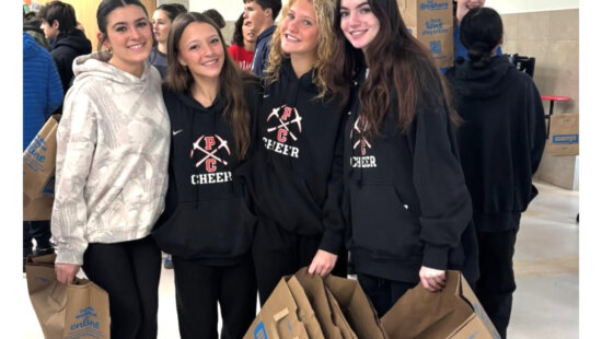 Park City High School cheerleaders help pack meal boxes as volunteers assemble about 1,000 holiday meals for families in Summit and Wasatch counties on Dec. 20.