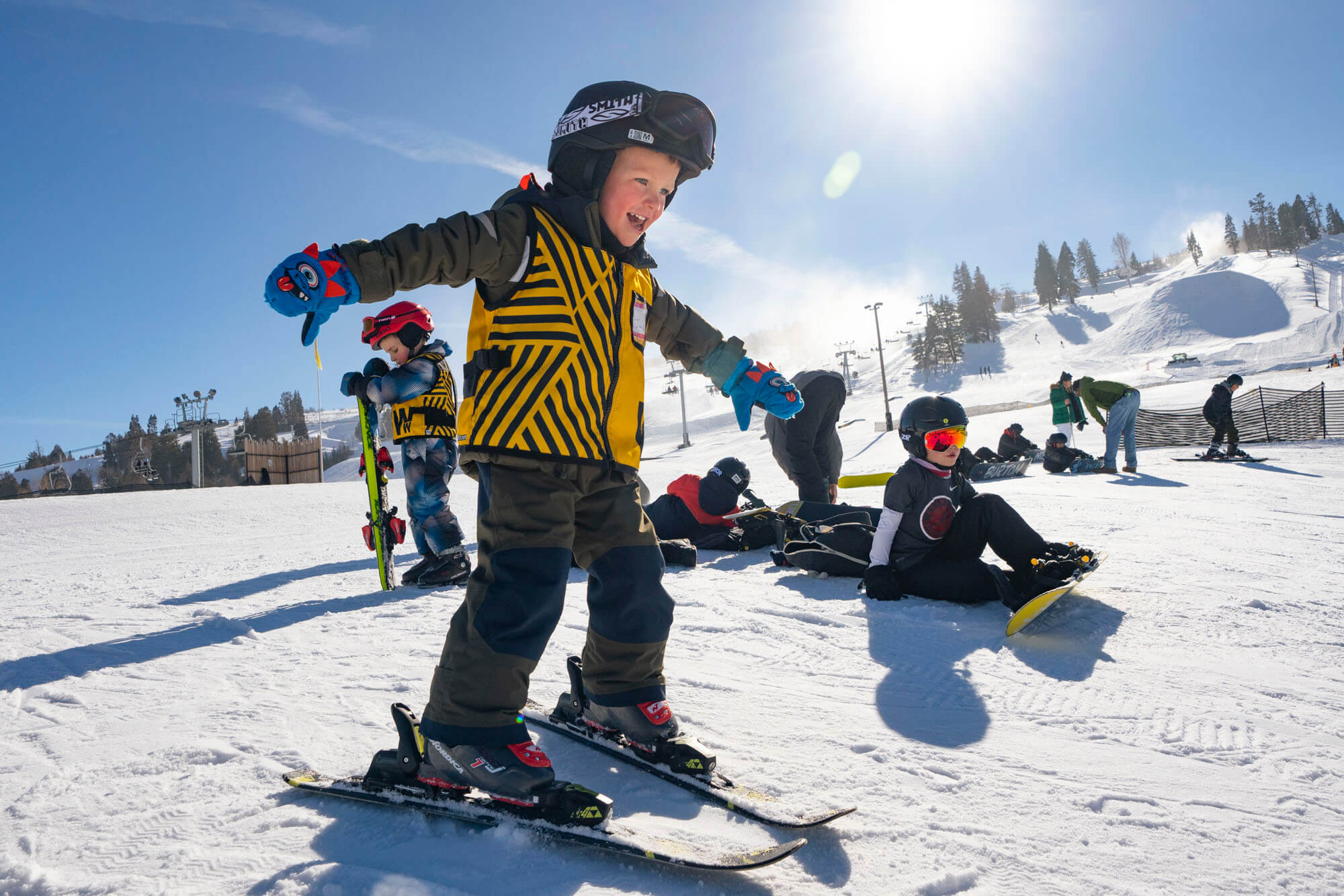 Skier on gentle snowy slope with mountain backdrop