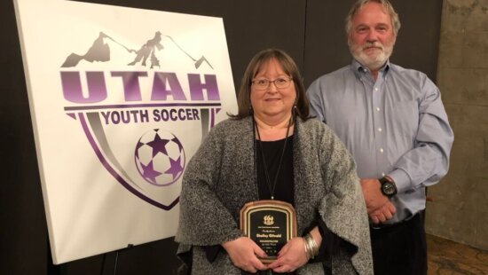 Shelley Gillwald accompanied by her husband, Pete, winning the UYSA Administrator of the Year Award a few years ago.