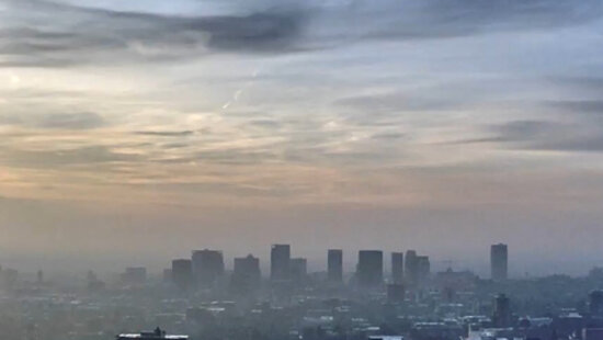 Salt Lake City’s skyline fades behind a thick winter inversion as fine-particle pollution builds in the valley, prompting air-quality warnings and burn restrictions this week.