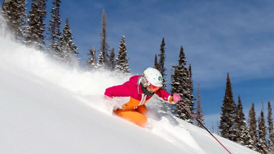 A skier carves through fresh powder at Deer Valley Resort.