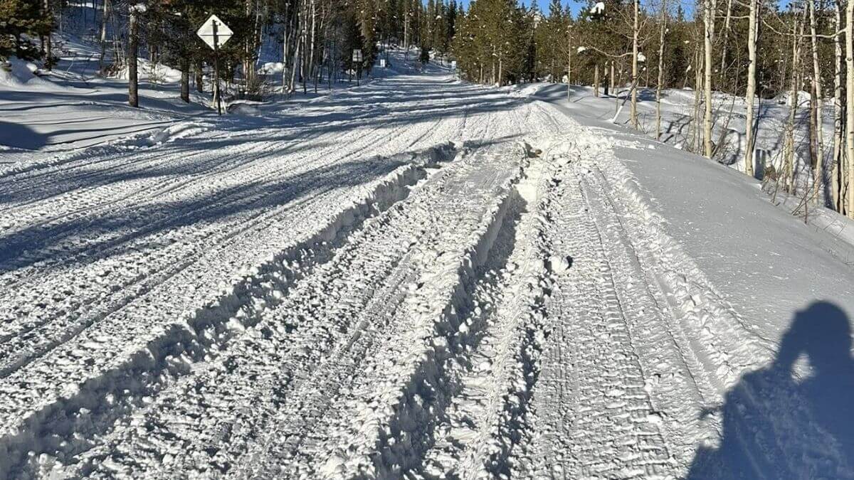 Deep ruts on the Mirror Lake snowmobile track created by large vehicles illegally driving on the road.
