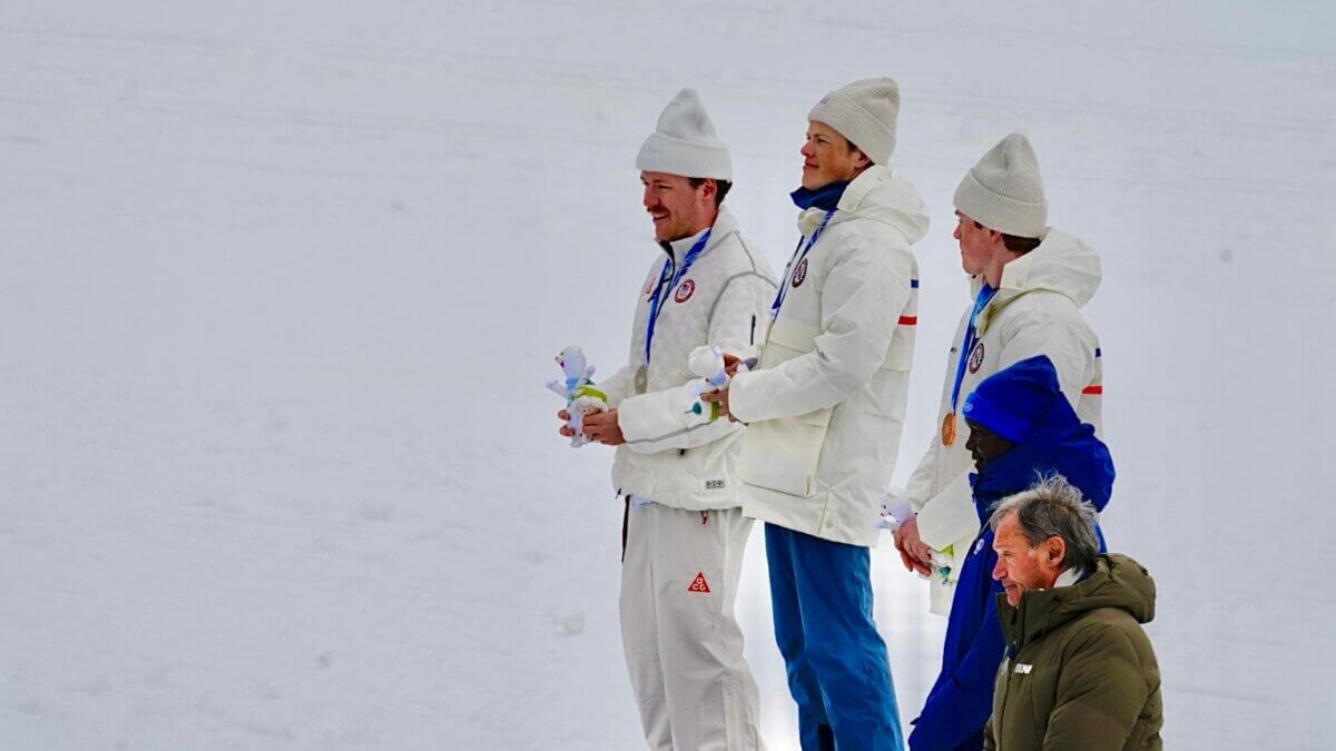 Ben Ogden (in front) of Team USA, with his Milano Cortina Olympic Cross Country gold medal