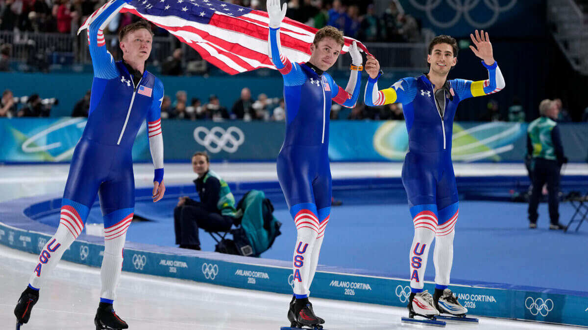 Team USA with Ethan Cepuran, white armband, Casey Dawson, red armband, Emery Lehman, yellow armband, celebrate winning the silver medal in the final of the men's team pursuit speedskating race at the 2026 Winter Olympics, in Milan, Italy, Tuesday, Feb. 17, 2026.