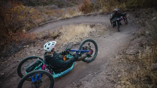 Adaptive mountain bikers out on the trail.